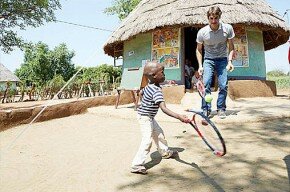 Roger Federer visiting the Growing to Read project in Limpopo, reading Sunshine and New Heights books